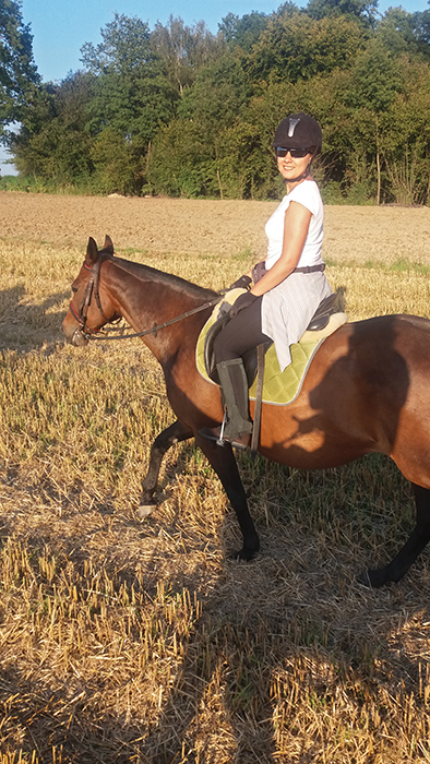 Barbara, Clinical Operations Leader at Parexel, Horseback riding in a field